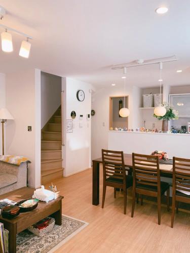 a living room and dining room with a table and chairs at Uhome Ikebukuro Villa 2 in Tokyo