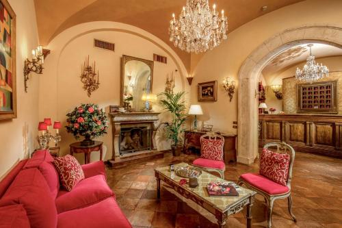 a living room with red furniture and a fireplace at Boutique Hotel Campo de' Fiori in Rome