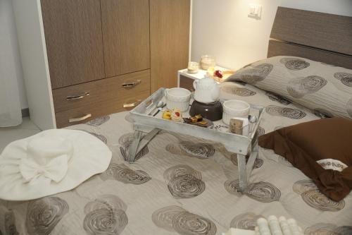 a bedroom with a bed with a tray on it at HOTEL VALLEVERDE in Corbara