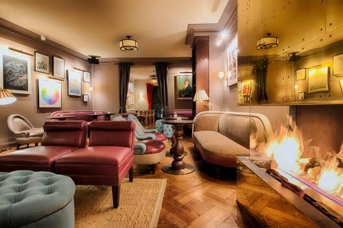 a living room with a fire in the fireplace at Mondrian Suites Berlin am Checkpoint Charlie in Berlin
