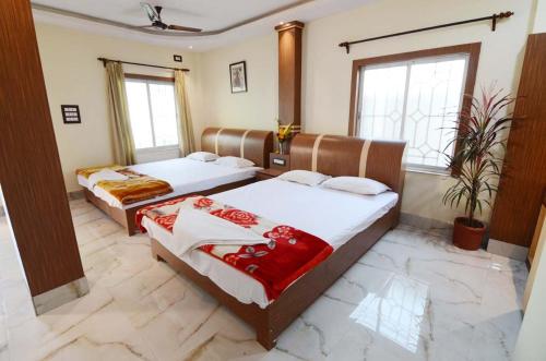 a room with two beds in a room at Royal Sundarban Wild Resort in Jharkhali