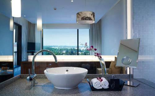 a bathroom with a sink and a large window at Taj Yeshwantpur Bengaluru in Bangalore