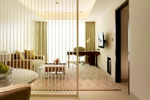 a living room with a table and a dining room at Taj Yeshwantpur Bengaluru in Bengaluru