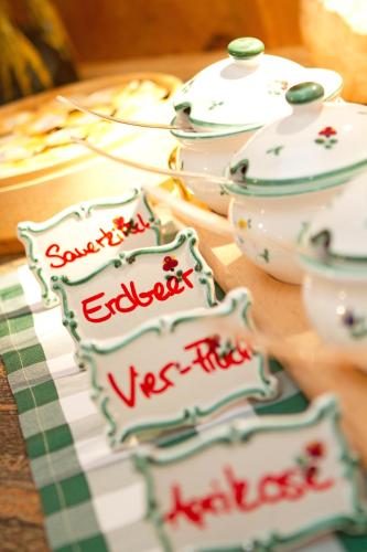 a table topped with plates and bowls on a table at Hotel Villa Post in Vulpera