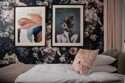 a bedroom with three pictures on the wall and a bed at The Vault Hotel, WorldHotels Crafted in Helsingborg
