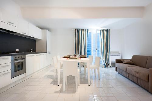 a kitchen and living room with a table and a couch at NerOssidiana in Acquacalda