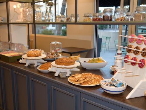a buffet with plates of food on a table at Hotel Abc in Cervia