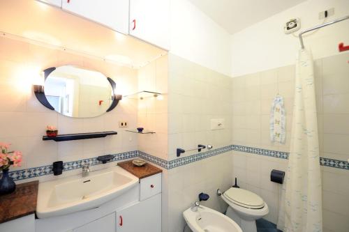 a bathroom with a sink and a toilet and a mirror at LA TERRAZZA SUL MARE in Ravello