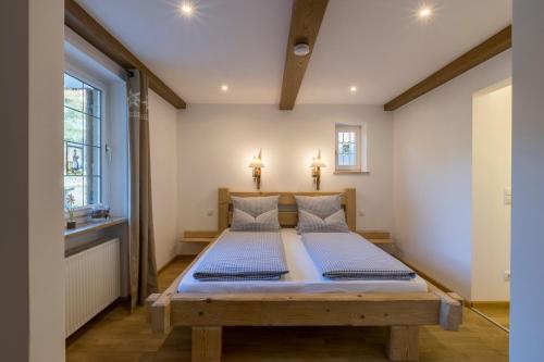 1 dormitorio con cama de madera en una habitación en Ferienhaus Badersee, en Grainau