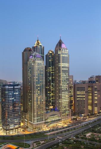 a group of tall buildings in a city at night at Sofitel Abu Dhabi Corniche in Abu Dhabi