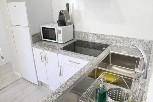 Η κουζίνα ή μικρή κουζίνα στο Apartamentos Logroño Centro