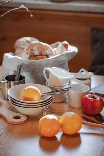 a table with eggs and oranges and a basket of bread at Club Nordic in Sankt Anton am Arlberg