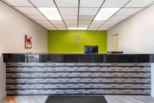 an office reception counter with a green wall at Quality Inn in Fairborn