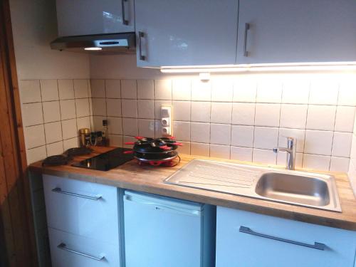 a kitchen with a sink and a counter top at Studio Les Drus / Studio du Brévent in Chamonix