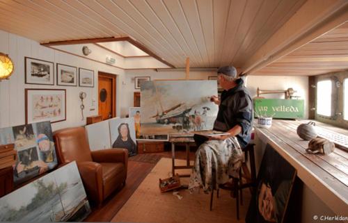 a man sitting at a counter in a room at Hôtel Kermor in Concarneau