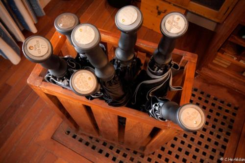 a group of clocks on a wooden table at Hôtel Kermor in Concarneau