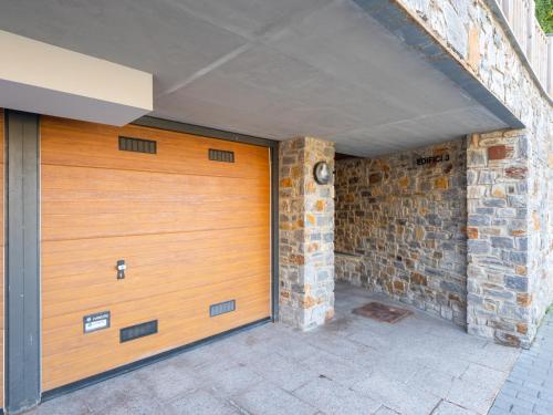 a wooden garage door with a brick wall at SOLDEU cosy home in Soldeu
