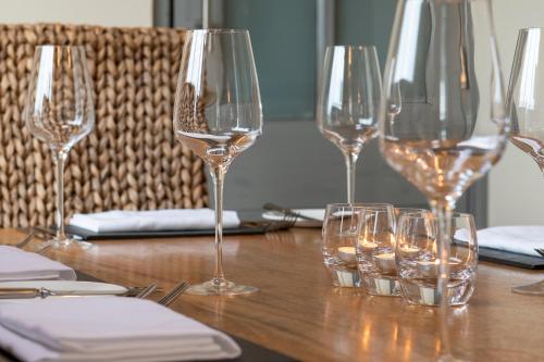 a group of wine glasses sitting on a table at Y Branwen Restaurant & Rooms - Adult Only and Dog Friendly in Harlech