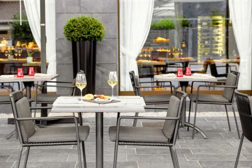 a table and chairs in a restaurant with wine glasses at Grand Hotel Campione in Campione dʼItalia