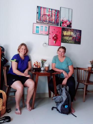two women sitting at a table in a room at candyinn in Hue