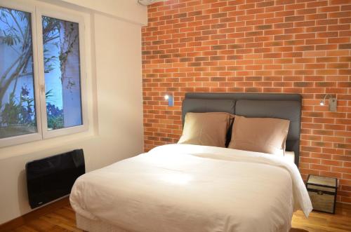 Un pat sau paturi într-o cameră la Wood & Bricks, appartement 1 chambre au calme - centre ville - Wifi