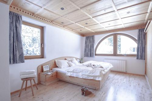 a bedroom with a bed and a large window at Club Nordic in Sankt Anton am Arlberg