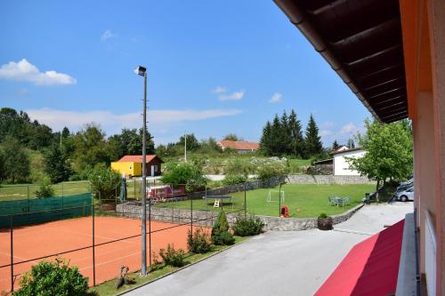 a view of a tennis court from a building at Bed and Breakfast Restaurant DP in Donji Zvečaj