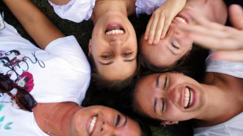 a group of women laying in the grass together at Agriturismo Casa Agricola Rossi Appartamenti in Casentino in Soci
