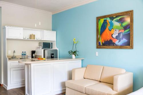 a living room with a couch and a table and a microwave at Margaritaville Beach Resort Playa Flamingo in Playa Flamingo
