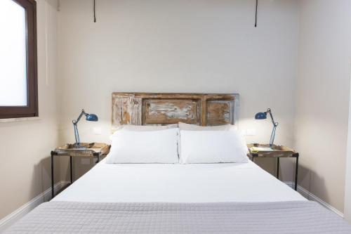 a bedroom with a large bed with two night stands at White House in Cagliari