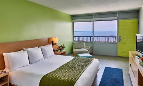a bedroom with a bed and a view of the ocean at Harbor Hotel Provincetown in Provincetown