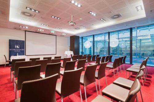 a conference room with chairs and a whiteboard at Exe Budapest Center in Budapest