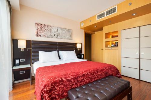 a bedroom with a large bed with a red blanket at Exe Budapest Center in Budapest