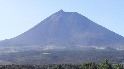 a mountain in the distance with a view at Azores Hibiscus House - Mountain and Sea in São Roque do Pico