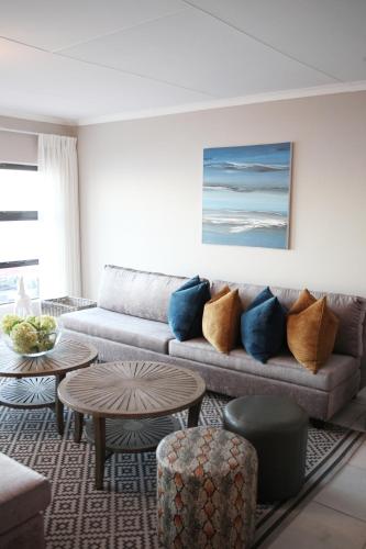 a living room with a couch and a table at Eden Guesthouse B&B in Dana Bay