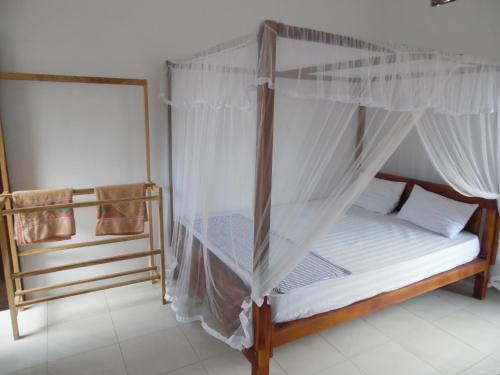 a bedroom with a bed with a canopy at Allan Guest Mirissa in Bandaramulla