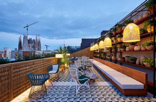 a balcony with chairs and tables on a building at Radisson Blu 1882 Hotel, Barcelona Sagrada Familia in Barcelona