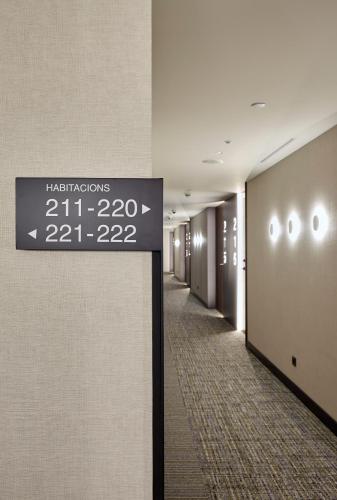 a hallway with a sign on the wall of a building at Radisson Blu 1882 Hotel, Barcelona Sagrada Familia in Barcelona