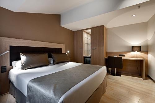a bedroom with a large bed in a room at Catalonia Atocha in Madrid