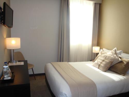 a hotel room with a bed and a window at TURIM Aveiro Palace Hotel in Aveiro