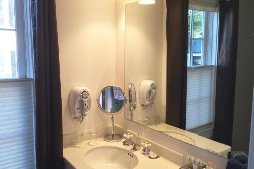 a bathroom with a sink and a mirror at Benchmark Inn in Provincetown
