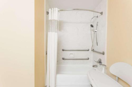 uma casa de banho com chuveiro e WC em Super 8 by Wyndham Hull Street Midlothian Richmond Area em Midlothian