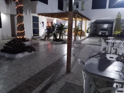 a room with tables and chairs and a room with a fireplace at Hotel La Posada Del Ingles in Chiclayo