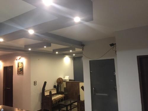 a room with a ceiling with lights on it at H100 Pyramids View in Giza