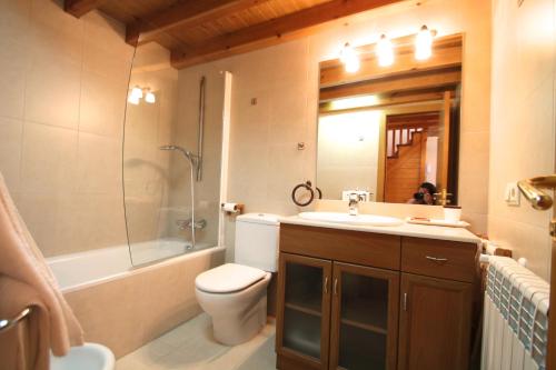 a bathroom with a toilet and a sink and a shower at Borda Pascol, Atico Duplex en Tarter Zona Grandvalira in Canillo