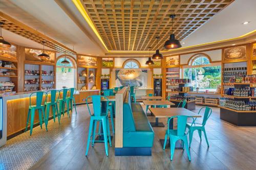 a restaurant with blue chairs and tables in it at Bahia Principe Luxury Ambar - Adults Only All Inclusive in Punta Cana