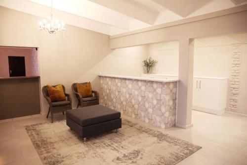 a living room with a table and two chairs at Eden Guesthouse B&B in Dana Bay