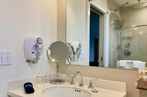 a bathroom with a sink and a mirror at Benchmark Inn in Provincetown