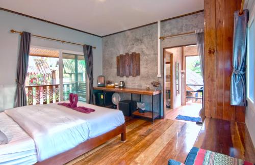 Rapala Rock Wood Resort- SHA Plus في شاطئ رايلي: غرفة نوم مع سرير ومكتب