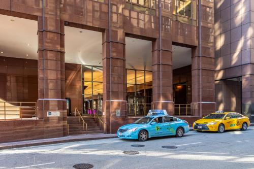 two cars parked in front of a building at The Buckingham Hotel in Chicago